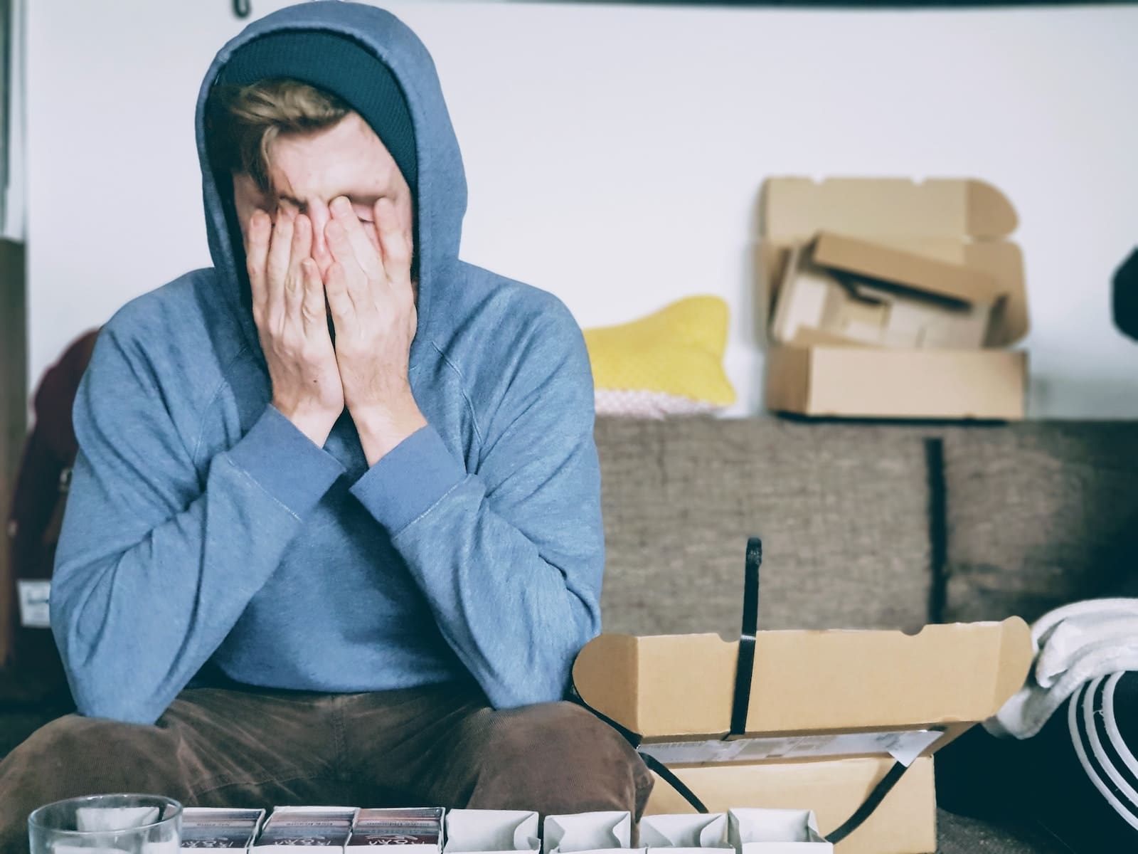 man covering face with both hands while sitting on bench, burnout in streaming